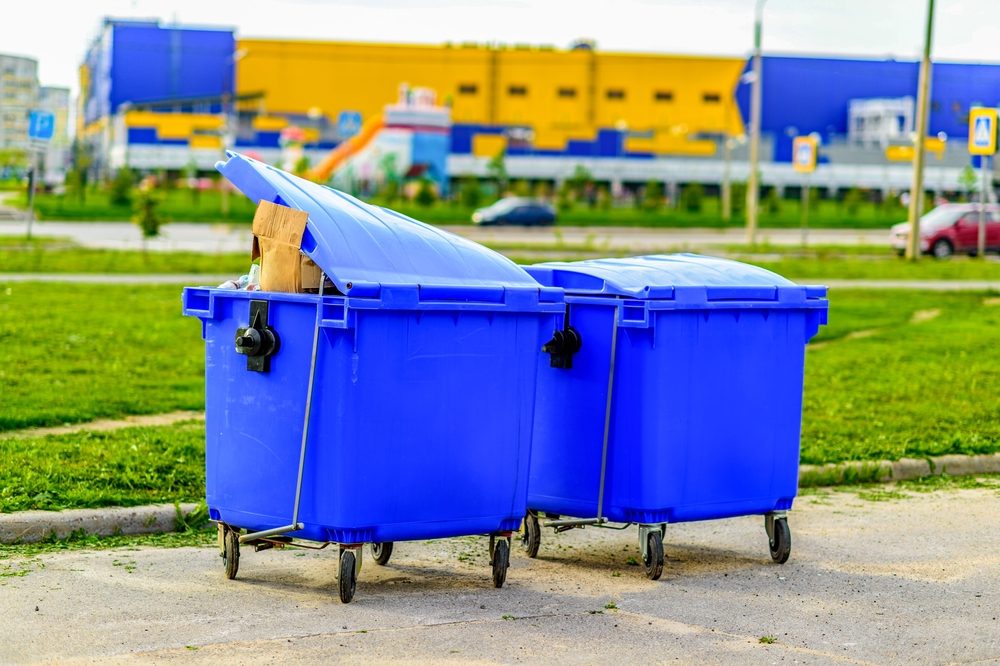 two-blue-overfilled-waste-bins